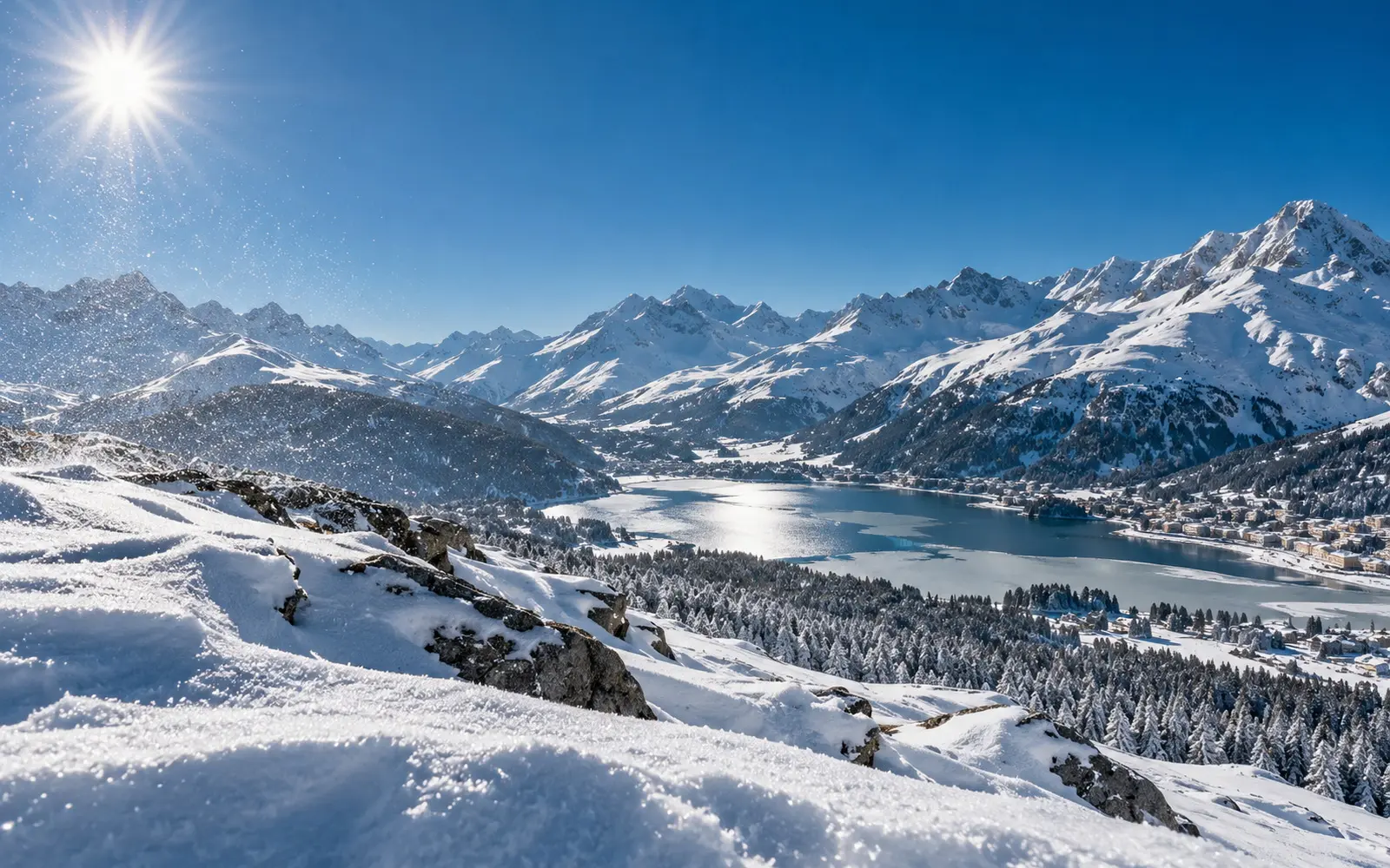 Snow crystals glittering in the air over a snowy ridge under a deep blue sky